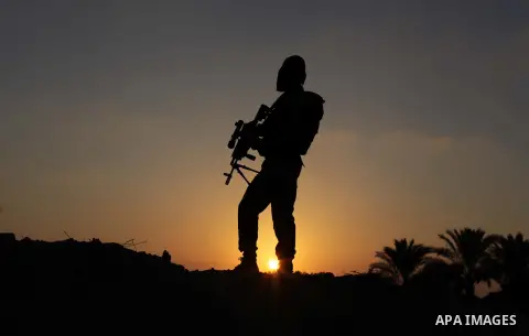 Masked militants from al-Quds Brigades the armed wing of the Islamic Jihad organization, guard the eastern border of Gaza City, on July 15, 2013. Photo by Ashraf Amra