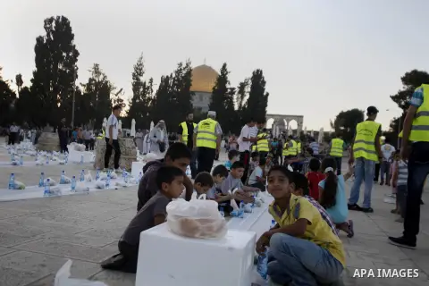 Palestinians of the Human Appeal International prepare for Iftar (the evening meal during the Islamic month of Ramadan) to break their fasting as they attending a banquet at al-Aqsa mosque compound in the old city of Jer...