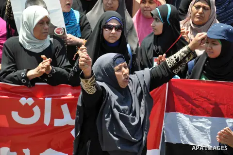 Supporters of ousted Egyptian President Mohammed Morsi march through the residential neighborhood of Garden City, passing several diplomatic missions, but avoiding the U.S. embassy, in Cairo, Egypt, Saturday, July 21, 20...