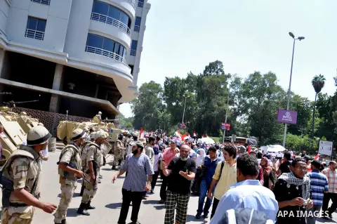 Supporters of ousted Egyptian President Mohammed Morsi march through the residential neighborhood of Garden City, passing several diplomatic missions, but avoiding the U.S. embassy, in Cairo, Egypt, Saturday, July 21, 20...