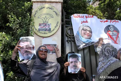 Supporters of ousted Egyptian President Mohammed Morsi march through the residential neighborhood of Garden City, passing several diplomatic missions, but avoiding the U.S. embassy, in Cairo, Egypt, Saturday, July 21, 20...