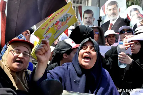 Members of the Muslim Brotherhood and supporters of ousted Egyptian President Mohamed Mursi shout slogans during a demonstration outside al-Noor mosque in Cairo July 22, 2013. The family of ousted Egyptian President Moha...