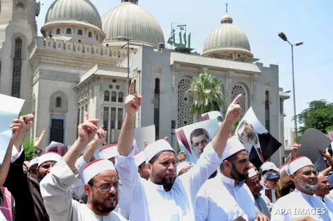 Members of the Muslim Brotherhood and supporters of ousted Egyptian President Mohamed Mursi shout slogans during a demonstration outside al-Noor mosque in Cairo July 22, 2013. The family of ousted Egyptian President Moha...