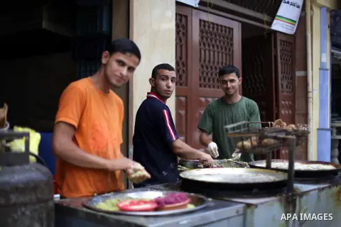 A Palestinian displays dishes of traditional chickpeas known as "Falafel" during Ramadan in Gaza city, on July 11, 2013 in Gaza City. During Ramadan, one of the five main religious obligations under Islam, Muslims are re...
