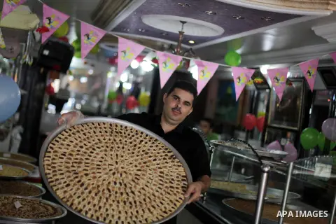 A Palestinian vendor sells sweets after the results of high school exams, known as ''Tawjihi'' in Gaza city, on July 25, 2013. The Ministry of Education in Gaza Strip announced the final results coincide with the West Ba...