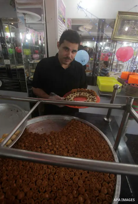 A Palestinian vendor sells sweets after the results of high school exams, known as ''Tawjihi'' in Gaza city, on July 25, 2013. The Ministry of Education in Gaza Strip announced the final results coincide with the West Ba...