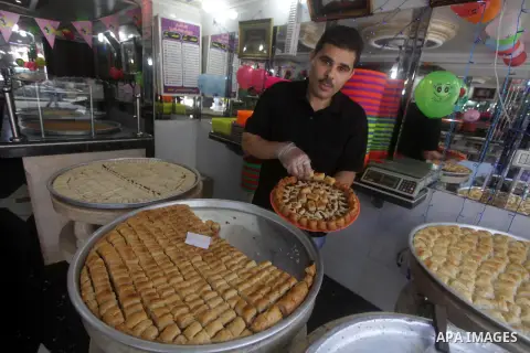A Palestinian vendor sells sweets after the results of high school exams, known as ''Tawjihi'' in Gaza city, on July 25, 2013. The Ministry of Education in Gaza Strip announced the final results coincide with the West Ba...