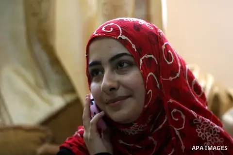 A Palestinian high school student, Ahlam AL Balaawi 99.6, celebrates with her family after heard the results of her final exams known as ''Tawjihi'' in Rafah in southern Gaza Strip, on July 25, 2013. The Ministry of Educ...