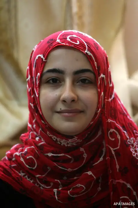 A Palestinian high school student, Ahlam AL Balaawi 99.6, celebrates with her family after heard the results of her final exams known as ''Tawjihi'' in Rafah in southern Gaza Strip, on July 25, 2013. The Ministry of Educ...