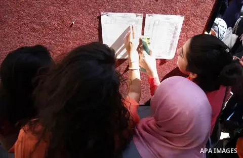 Palestinian students look for their names in the results of final high school exams, known as "Tawjihi" in Jerusalem on July 25, 2013. The Ministry of Education in Gaza Strip and the West Bank announced the results toget...