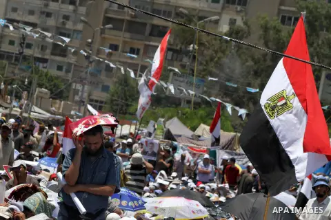 Members of the Muslim Brotherhood and supporters of ousted Egyptian President Mohamed Mursi take part in a rally around Rabaa Adawiya square where they are camping, in Cairo July 26, 2013. Mursi is under investigation fo...