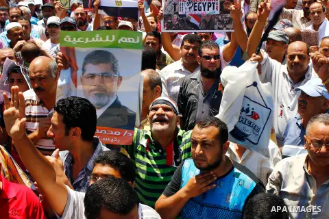 Supporters of the Muslim Brotherhood and Egypt's ousted president Mohamed Morsi take part in a demonstration in the Mediterranean city of Alexandria on July 26, 2013. Tense Egypt braced today for a showdown in the street...