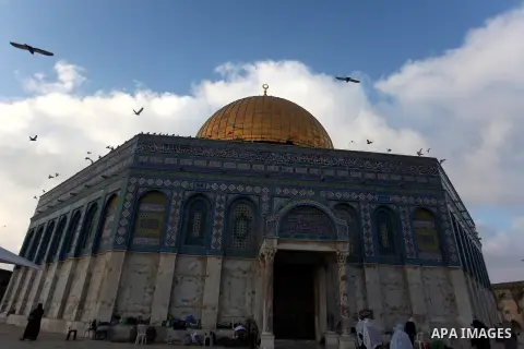 Palestinians walk in front of the Dome of the Rock mosque, at al-Aqsa mosque compound, during the Muslims fasting month of Ramadan, in Jerusalem's old city, Aug 04, 2013. Throughout the month, devout Muslims must abstain...