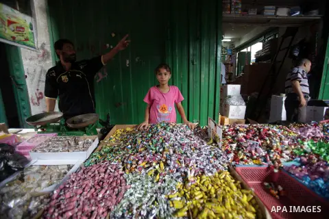 A Palestinian vendor displays chocolate during preparations for the Eid Al-Fitr feast at the market in Khan Youns southern in Gaza city on Aug 07, 2013, as Muslims over the world prepare to celebrate Eid al-Fitr, a three...