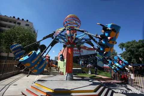 Palestinians enjoy a ride in an amusement park on the second day of Eid al-Fitr, marking the end of Islam's fasting holy month of Ramadan, in the west Bank city of Ramallah on Aug. 09, 2013. Muslims around the world are...