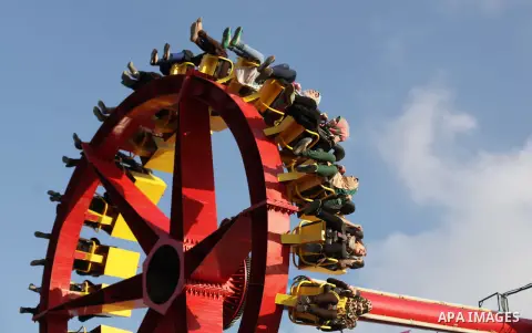 Palestinians enjoy a ride in an amusement park on the third day of Eid al-Fitr, marking the end of Islam's fasting holy month of Ramadan, in Gaza City on August 10, 2013. Photo by Ashraf Amra
