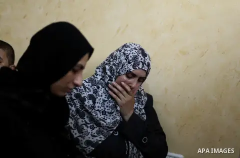 Palestinian relatives of Hussein Awadullah, 32, grieve during his funeral in the Nuseirat Refugee Camp, southern Gaza Strip, Sunday, Aug. 11, 2013. Awadullah was killed in an Israeli operation on the border with Gaza on...