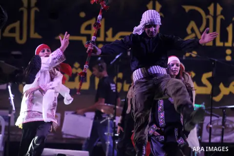 Palestinians perform during the first night of Jerusalem's Summer Nights Festival in the occupied West Bank village of Beit Anan northern Jerusalem, in Aug 15, 2013. Photo by Issam Rimawi