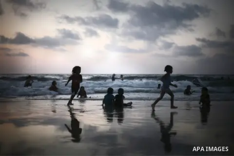 Palestinians enjoy swimming on the sea at Gaza beach during a summer holiday on Aug. 17, 2013. Gazans escape to the beach and out from their homes during heat wave and power outages. Photo by Ezz al-Zanoon