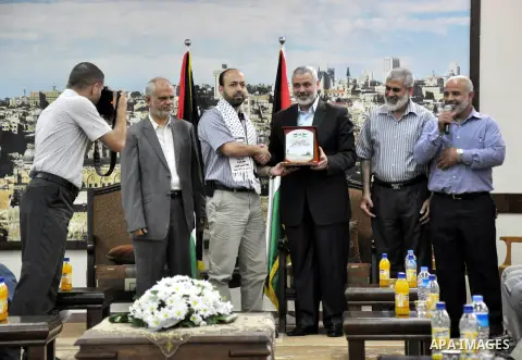 Palestinian Prime Minister in Gaza strip, Ismail Haniyeh, honors the prisoners released, in Gaza city on Aug. 19, 2013. Israel released 26 long-held Palestinian prisoners in a planned goodwill gesture hours ahead of a sc...