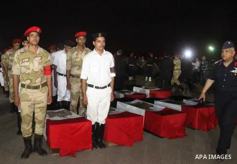 Egyptians gather around the coffins with the Egyptian Sinai policemen who were killed in Arish, during their funeral at Almaza military airport, Egypt, 19 August 2013. Egyptian security forces sealed off the Sinai Penins...