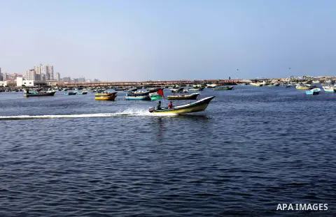 Palestinian fishermen work on their boats during a rally inside the port of Gaza to protest on the Israeli siege on the Gaza Strip and the five-year anniversary of the entry of first two ships solidarity with Gaza, in Ga...