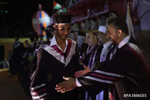 Fadi al-Shami, 21, a Palestinian blind youth attends his graduation ceremony in Gaza City on Aug 17, 2013. al-Shami lost his sight after he was injured by an Israeli airstrike next to his family home at al-Musaddar villa...
