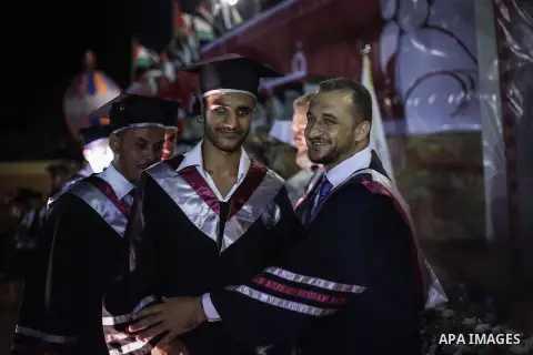 Fadi al-Shami, 21, a Palestinian blind youth attends his graduation ceremony in Gaza City on Aug 17, 2013. al-Shami lost his sight after he was injured by an Israeli airstrike next to his family home at al-Musaddar villa...