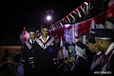 Fadi al-Shami, 21, a Palestinian blind youth attends his graduation ceremony in Gaza City on Aug 17, 2013. al-Shami lost his sight after he was injured by an Israeli airstrike next to his family home at al-Musaddar villa...