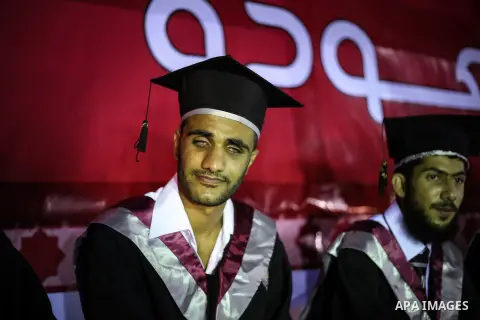 Fadi al-Shami, 21, a Palestinian blind youth attends his graduation ceremony in Gaza City on Aug 17, 2013. al-Shami lost his sight after he was injured by an Israeli airstrike next to his family home at al-Musaddar villa...