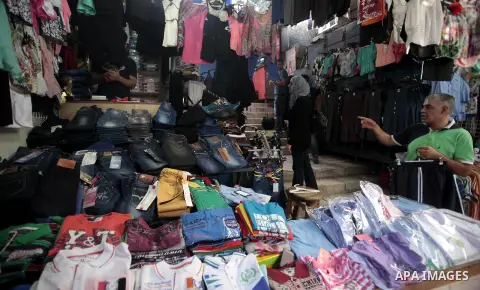 Palestinians shop during preperation for the new school year at a market in Jerusalem on Aug 22, 2013. Palestinian Ministry of Education announced the 25 August is the first day of new school year in the West Bank and Ga...