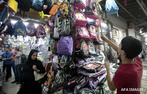 Palestinians shop during preperation for the new school year at a market in Jerusalem on Aug 22, 2013. Palestinian Ministry of Education announced the 25 August is the first day of new school year in the West Bank and Ga...