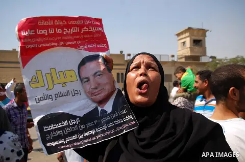 Supporters of Egypt's deposed autocrat Hosni Mubarak hold posters of him and chant slogans in front of Torah Prison, where Egypt's deposed autocrat Hosni Mubarak has been held, in Cairo, Egypt, Thursday, Aug. 22, 2013. E...