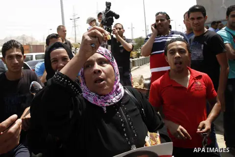 Supporters of Egypt's deposed autocrat Hosni Mubarak gather in front of Torah Prison, where Egypt's deposed autocrat Hosni Mubarak has been held, in Cairo, Egypt, Thursday, Aug. 22, 2013. Egypt's ousted leader Hosni Muba...