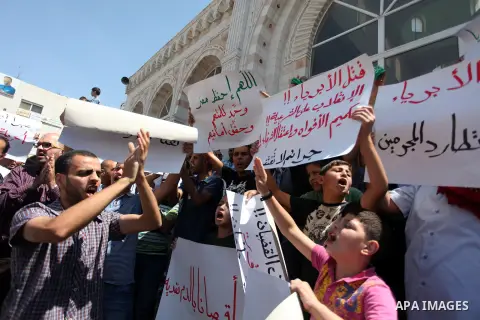 Palestinians raise their hands and four fingers, a sign that protesters say symbolizes the Rabaah al-Adawiya mosque in Cairo that was cleared last week by Egyptian security forces, during a rally in support of the ousted...