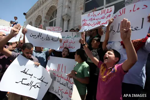 Palestinians raise their hands and four fingers, a sign that protesters say symbolizes the Rabaah al-Adawiya mosque in Cairo that was cleared last week by Egyptian security forces, during a rally in support of the ousted...