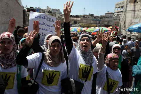 Palestinian girls raise their hands and four fingers, a sign that protesters say symbolizes the Rabaah al-Adawiya mosque in Cairo that was cleared last week by Egyptian security forces, during a rally in support of the o...
