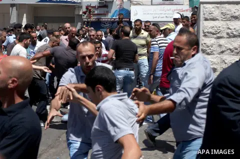 Palestinian protesters clash with plainclothes Palestinian Authority security during a rally in support of the ousted Egypt's President Mohamed Morsi organized by Hamas movement in the West Bank city of Ramallah, Friday,...