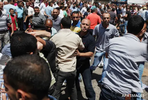 Palestinian protesters clash with plainclothes Palestinian Authority security during a rally in support of the ousted Egypt's President Mohamed Morsi organized by Hamas movement in the West Bank city of Ramallah, Friday,...
