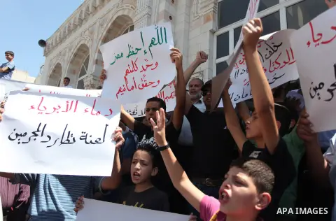 Palestinians raise their hands and four fingers, a sign that protesters say symbolizes the Rabaah al-Adawiya mosque in Cairo that was cleared last week by Egyptian security forces, during a rally in support of the ousted...