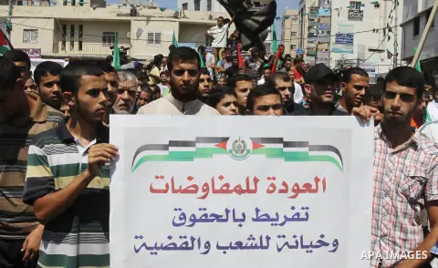 Palestinian supporters of Hamas and Islamic Jehad hold a placard during a protest against Palestinian-Israeli negotiations on August 23, 2013, in Gaza City. A senior Palestinian official accused on August 23 Israel of pr...