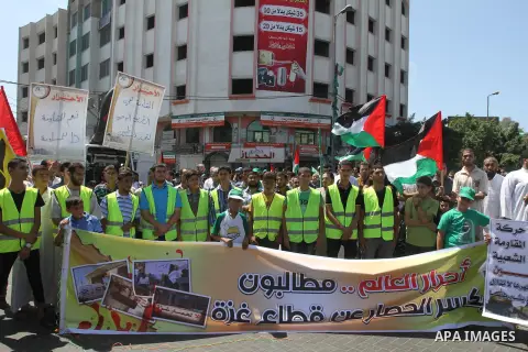 Palestinian supporters of Hamas and Islamic Jehad hold national flags during a protest against Palestinian-Israeli negotiations on August 23, 2013, in Gaza City. A senior Palestinian official accused on August 23 Israel...
