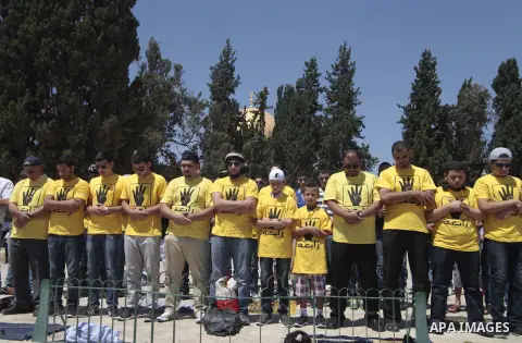 Palestinian supporters of the radical Islamist movement Hamas wears T-shirts with four fingers, as a symbol of the recent massacre in Rabaah al-Adawiya mosque as they attend prayers at al-Aqsa mosque compund in Jerusalem...