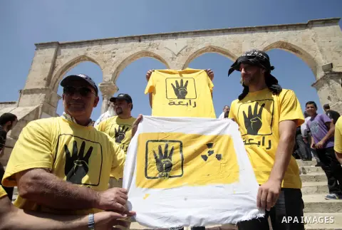Palestinian supporters of the radical Islamist movement Hamas raise their hands and four fingers, a sign that protesters say symbolizes the Rabaah al-Adawiya mosque in Cairo that was cleared last week by Egyptian securit...