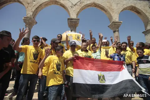 Palestinian supporters of the radical Islamist movement Hamas raise their hands and four fingers, a sign that protesters say symbolizes the Rabaah al-Adawiya mosque in Cairo that was cleared last week by Egyptian securit...