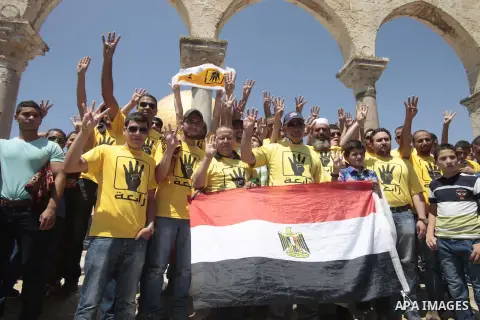 Palestinian supporters of the radical Islamist movement Hamas raise their hands and four fingers, a sign that protesters say symbolizes the Rabaah al-Adawiya mosque in Cairo that was cleared last week by Egyptian securit...