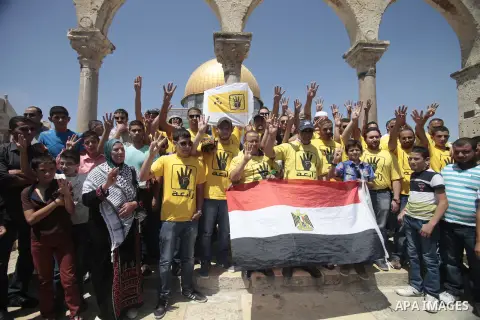 Palestinian supporters of the radical Islamist movement Hamas raise their hands and four fingers, a sign that protesters say symbolizes the Rabaah al-Adawiya mosque in Cairo that was cleared last week by Egyptian securit...