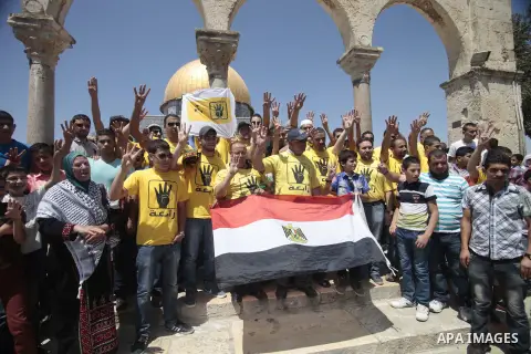 Palestinian supporters of the radical Islamist movement Hamas raise their hands and four fingers, a sign that protesters say symbolizes the Rabaah al-Adawiya mosque in Cairo that was cleared last week by Egyptian securit...