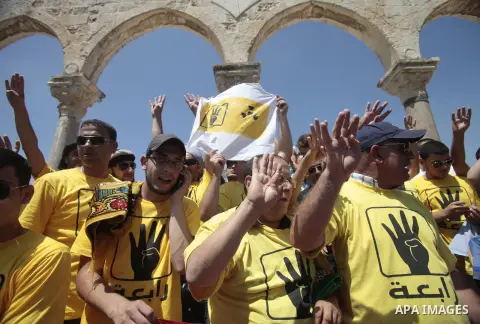 Palestinian supporters of the radical Islamist movement Hamas raise their hands and four fingers, a sign that protesters say symbolizes the Rabaah al-Adawiya mosque in Cairo that was cleared last week by Egyptian securit...