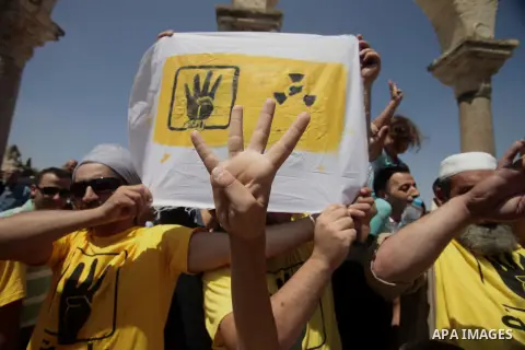Palestinian supporters of the radical Islamist movement Hamas raise their hands and four fingers, a sign that protesters say symbolizes the Rabaah al-Adawiya mosque in Cairo that was cleared last week by Egyptian securit...